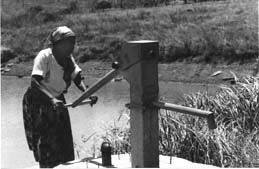 Woman using water pump