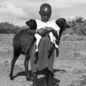 Maasai girl carrying goat